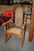 An oak framed small rocking chair