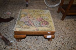 A small needlework topped footstool