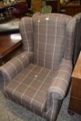 A pair of brown checked wingback armchairs