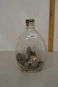 A Haig Whisky bottle filled with sixpence coins