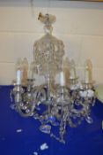 A 20th Century clear glass six branch chandelier with hanging glass drapes