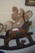 A pair of modern carved wooden models of chickens and a further rocking horse model (3)