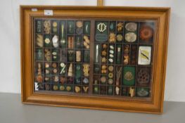 A modern framed display of various trinkets and objects by Myriad