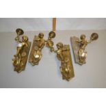Group of four brass wall mounted figural table lamps