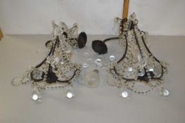 Pair of small iron framed hanging ceiling lights with glass drapes