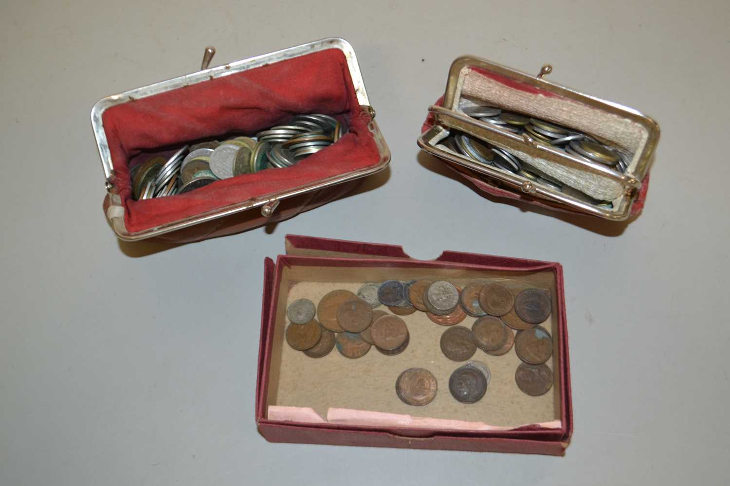 A collection of British and World coinage in two purses and a box, mainly circulated grade