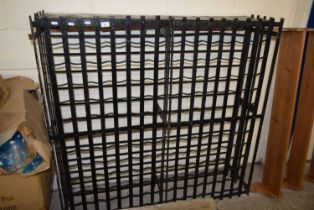 An iron wine rack with lockable doors