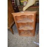 A pine wall mounted corner cupboard