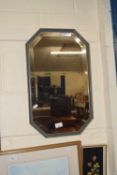 An octagonal framed wall mirror