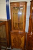 A pair of reproduction bow front corner cabinets