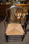 A rush seated shield back carver chair