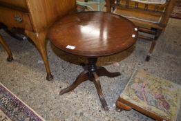 A circular top reproduction mahogany wine table