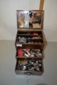 Small bronze effect table top cabinet containing assorted costume jewellery