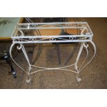 A white painted metal framed glass topped table