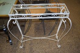 A white painted metal framed glass topped table
