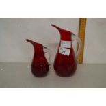 Two red glass jugs