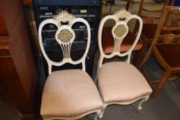 A pair of cream and gilt painted upholstered salon chairs
