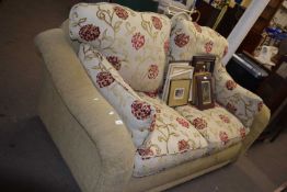 A two seater floral upholstered sofa