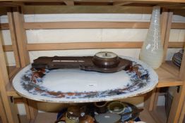 A large transfer decorated oval serving dish with a wall barometer and a contemporary glass vase