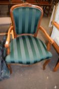 A green upholstered elbow chair
