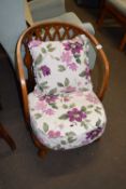A low easy chair with floral cushions