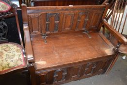 A stained oak monks bench