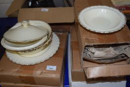 A quantity of cream and gilt decorated dinner wares