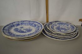 A collection of various blue and white meat plates and others