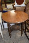 An early 20th Century oak two tier circular table on turned legs