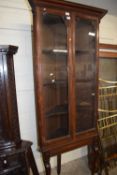 Late 19th or early 20th Century oak corner display cabinet with two glazed doors opening to a
