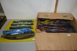 Box of 00 gauge model railway rolling stock together with various track and accessories