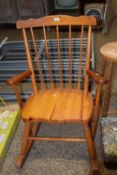 A pine stick back rocking chair