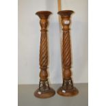 A pair of modern turned wooden candle stands