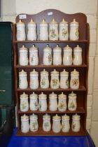 Collection of spice jars and accompanying wall rack