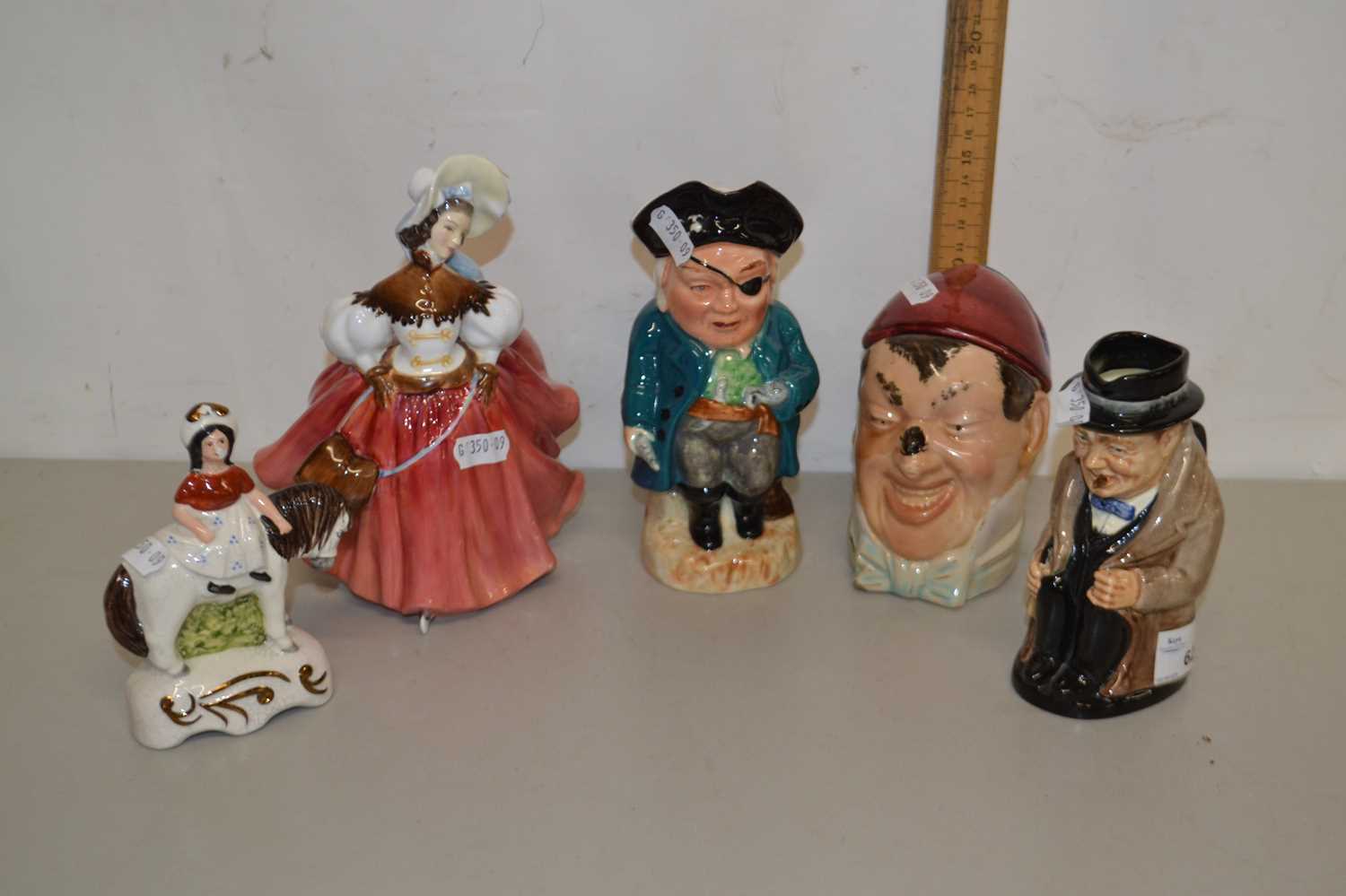 Mixed Lot: A Royal Doulton figurine The Skater together with a Royal Doulton Winston Churchill jug