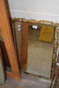 A bevelled wall mirror in gilt finish frame