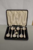 A case of silver plated soup spoons