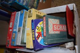 Box of various jigsaw puzzles and board games