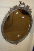 Modern oval wall mirror in foliate decorated frame