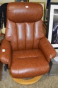 A brown leather recliner chair
