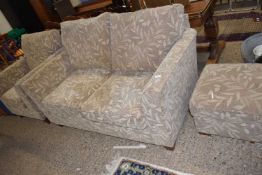 A modern two seater sofa with armchair and footstool