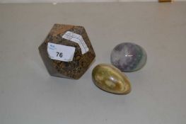 Two polished stone eggs and a further polished stone paperweight