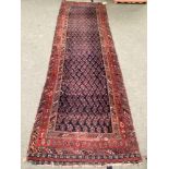 Small Persian style rug runner, with blue and red and all over geometric design, with central
