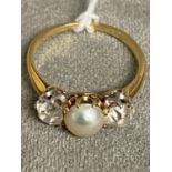 An unmarked yellow and white metal pearl and diamond ring, central button pearl with old cut diamond