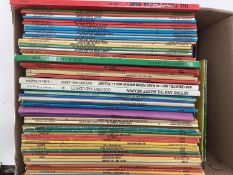 A large collection of Paperback Tin Tin and Asterix books