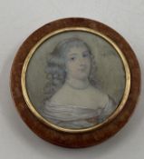 A circular walnut table snuff box, the cover set with a portrait of an C18th lady with yellow