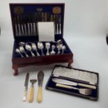 A boxed canteen of electro plated cutlery together with a boxed plated fish server