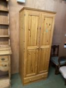 A modern pine two door wardrobe