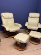 A pair of adjustable modern cream leather arm chairs, on circular revolving base, and a similar grey