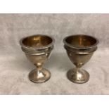 A pair of Georgian silver egg cups with gilt interiors by Solomon Hougham, London 1811, 98g